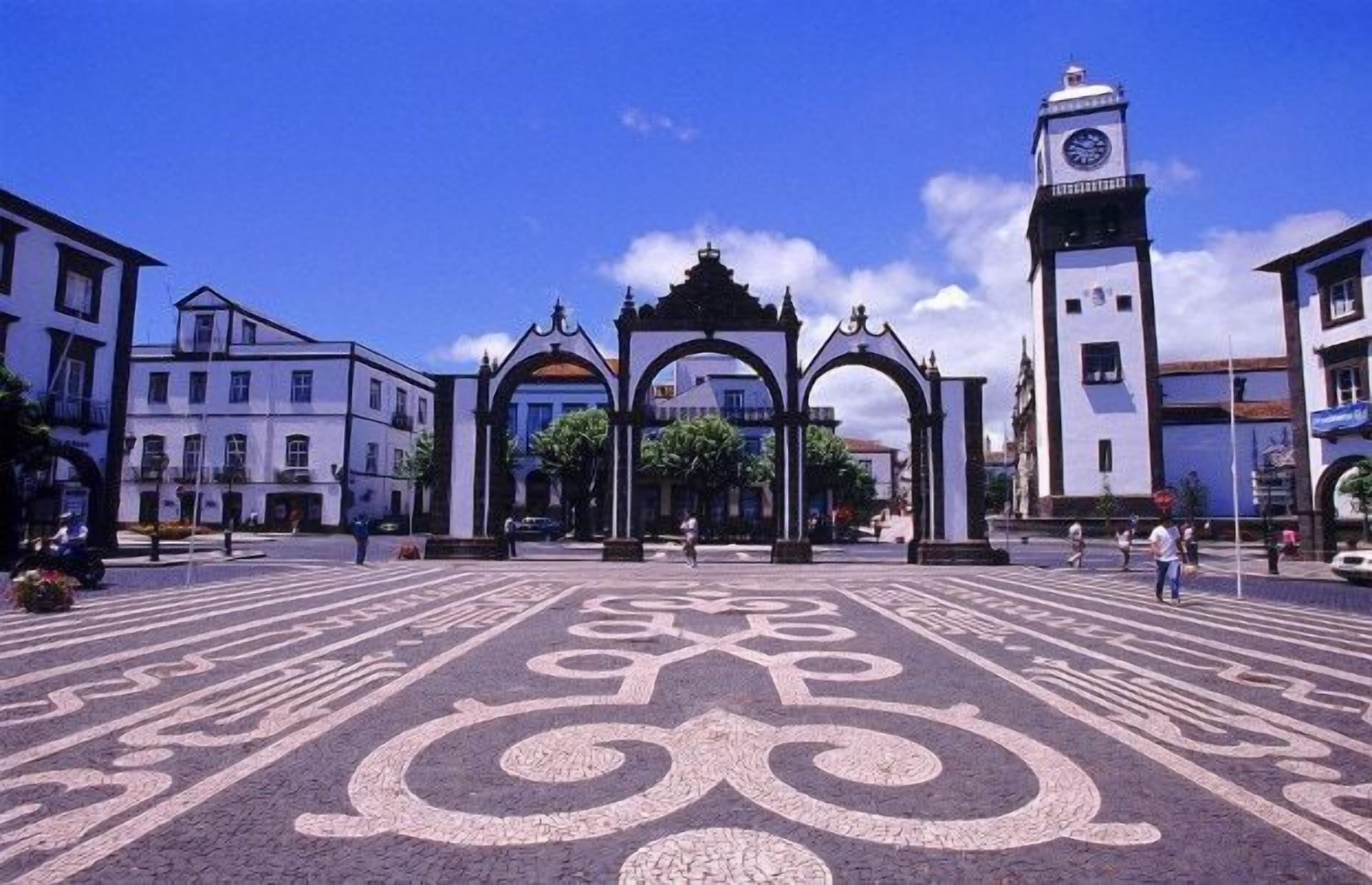 A plaza with ornate arches and a clock tower.