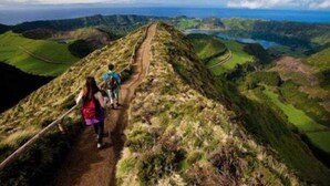 A hiking trail with a clear view of the surrounding landscape.