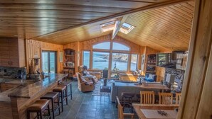 A spacious wooden cabin with a large dining area, kitchen, and a view of the ocean. - Dew Point Retreat, by Vinifera Homes (Gualala)