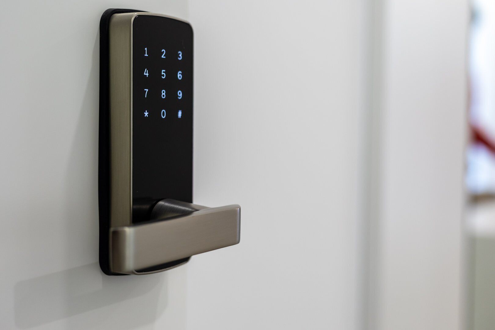 A modern door lock with a keypad and a push-button lock mechanism.