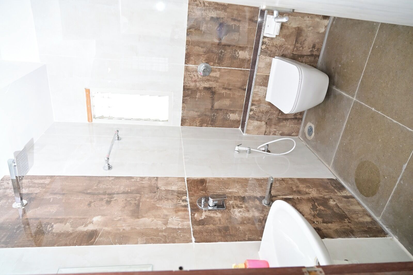 A bathroom with a shower, toilet, and sink.
