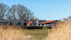 A residential area with houses, a clear sky, and a grassy path.