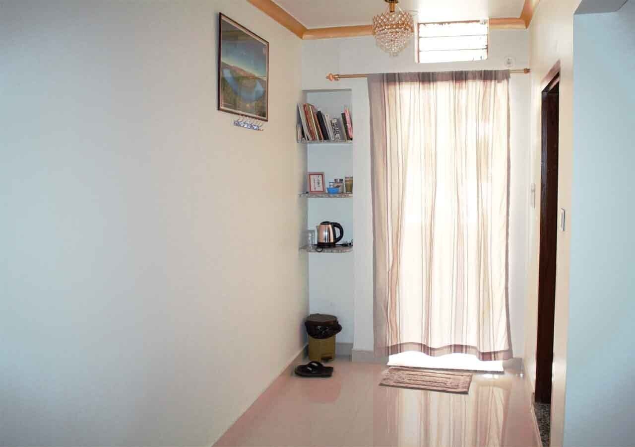 A hallway with a bookshelf, a radiator, and a door.