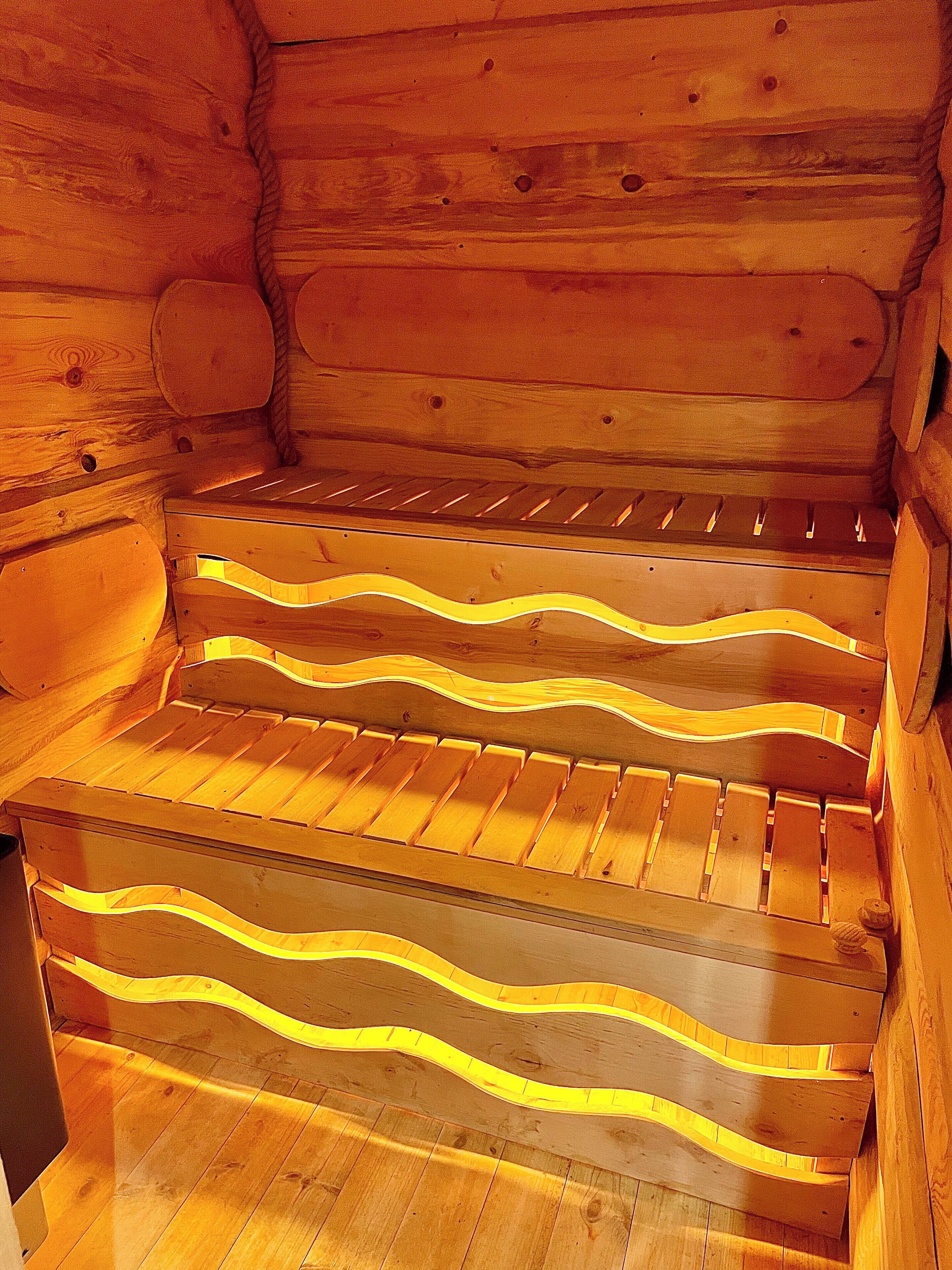 A wooden staircase with a unique wavy design and a warm, ambient light.