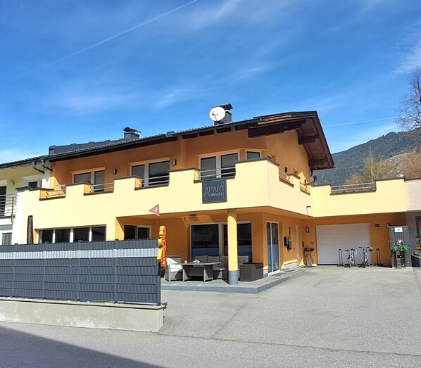 A two-story building with a flat roof, a satellite dish, and a flag. - Holiday Apartment 'Apart Annabell' with Mountain View, Private Terrace and Wi-Fi (Oetz)