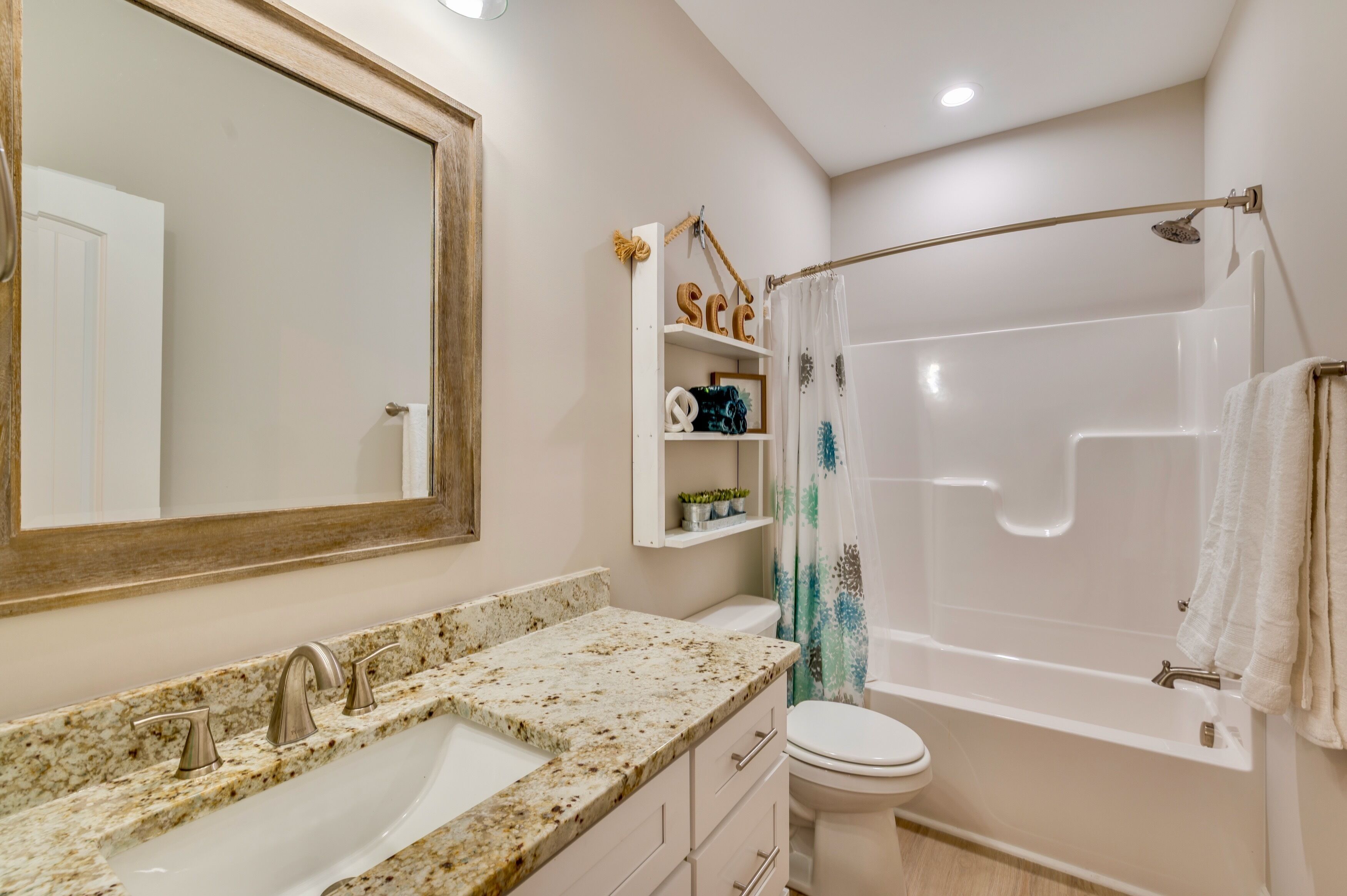 A bathroom with a sink, toilet, and bathtub.