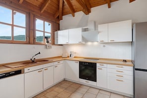 A kitchen with white cabinets, a dishwasher, an oven, and a refrigerator. - Apartment 'Idyll 1' with Mountain View, Balcony and Wi-Fi (Erfweiler)