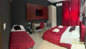 Deluxe Triple Room, City View | Desk, laptop workspace, blackout drapes, iron/ironing board