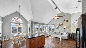 A spacious kitchen with a large island, wooden flooring, and a ceiling fan. - Top-Floor 3BR Ocean City w/ Porch + Parking (Ocean City)