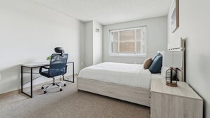 A bedroom with a bed, a desk, and a chair. - Legacy at Imperial Village 1108 I 1 Bed 1 Bath (Ric hmond)