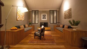 A modern living room with a sofa set, a coffee table, and a TV. - Argus Residence (George Town)
