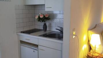 Fridge, microwave, toaster, dining tables