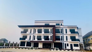 A multi-story building with a flat roof, large windows, and a central entrance. - Slavan Suites & Apartments (Owerri)