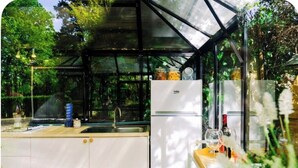 A kitchen with a glass enclosure, white cabinets, and a refrigerator. - Romantic bedroom in +600years old villa, with pool view (Grassina)