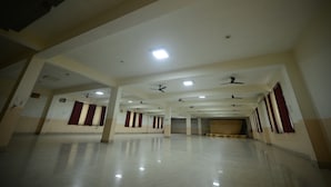 A spacious, well-lit hall with multiple ceiling fans and recessed lighting. - Vasuh Mhangglam (Bilha)