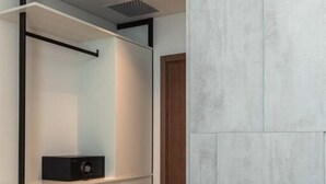 A modern bedroom with a built-in wardrobe, a bedside table, and a large bed. - Marbella Sol (Ksamil)