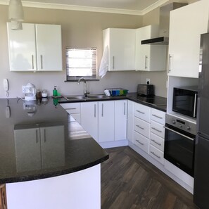 Premium Cottage, Garden View | Private kitchen | Full-size fridge, oven, stovetop, toaster