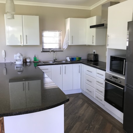 Premium Cottage, Garden View | Private kitchen | Full-size fridge, oven, stovetop, toaster