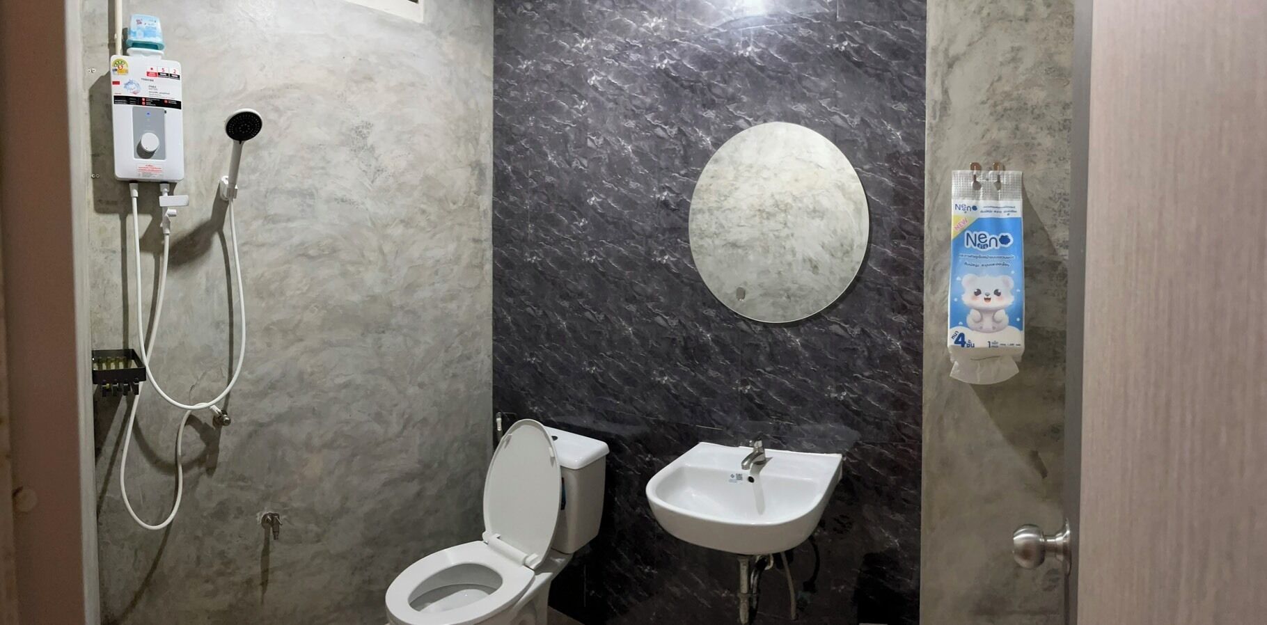 A bathroom with a toilet, bidet, and sink.