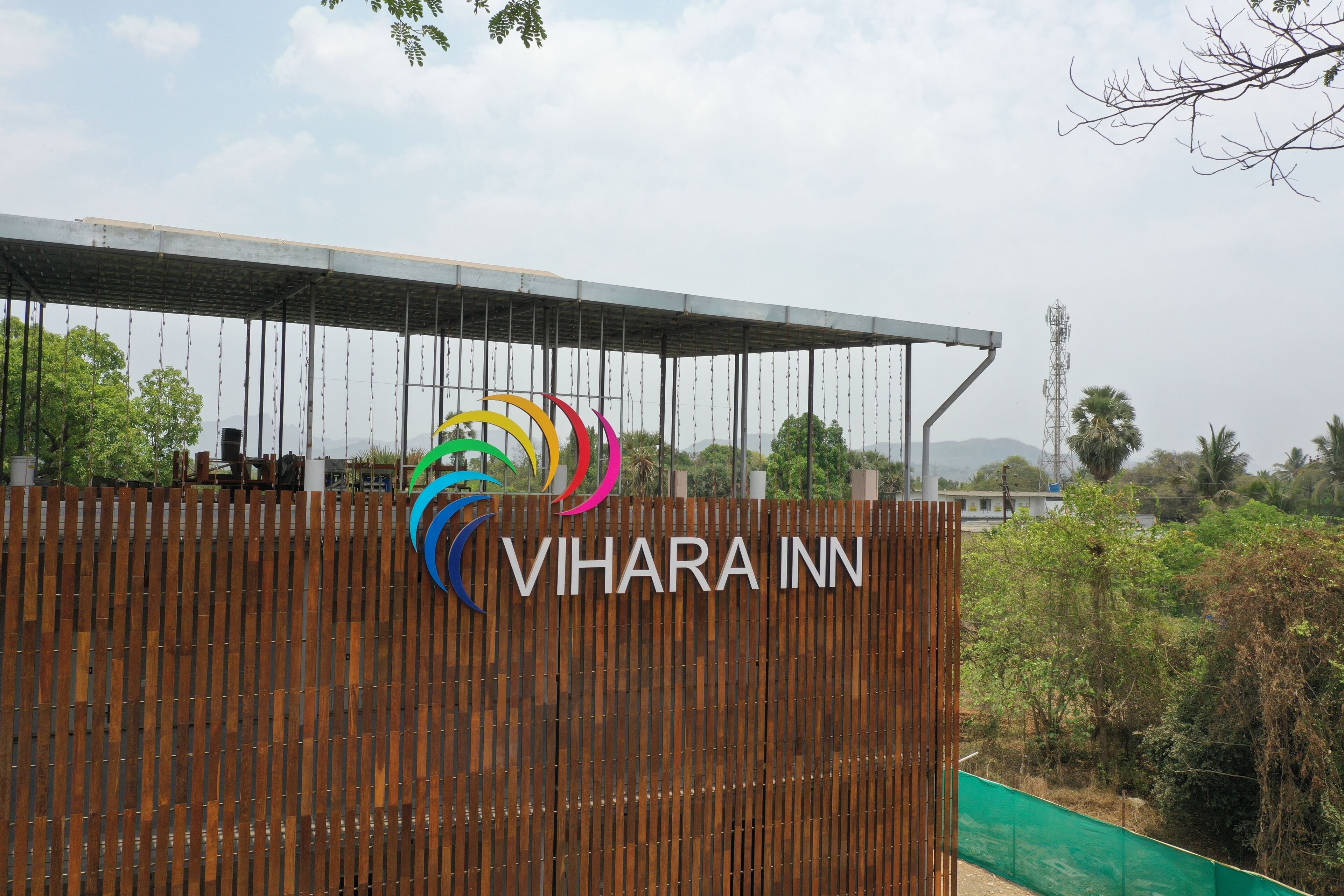 A sign for Vihara Inn with a colorful logo.