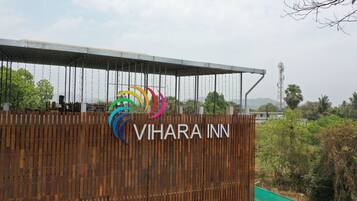 A sign for Vihara Inn with a colorful logo.