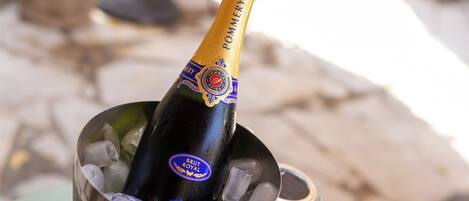 A bottle of Brut Royal champagne in a metal bucket with ice cubes.