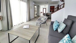 A modern living room with a sofa, armchair, and coffee table. - Villa Anny, heated pool, ideal for families! (PLAYA BLANCA)