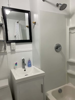Shower, hair dryer, towels, shampoo