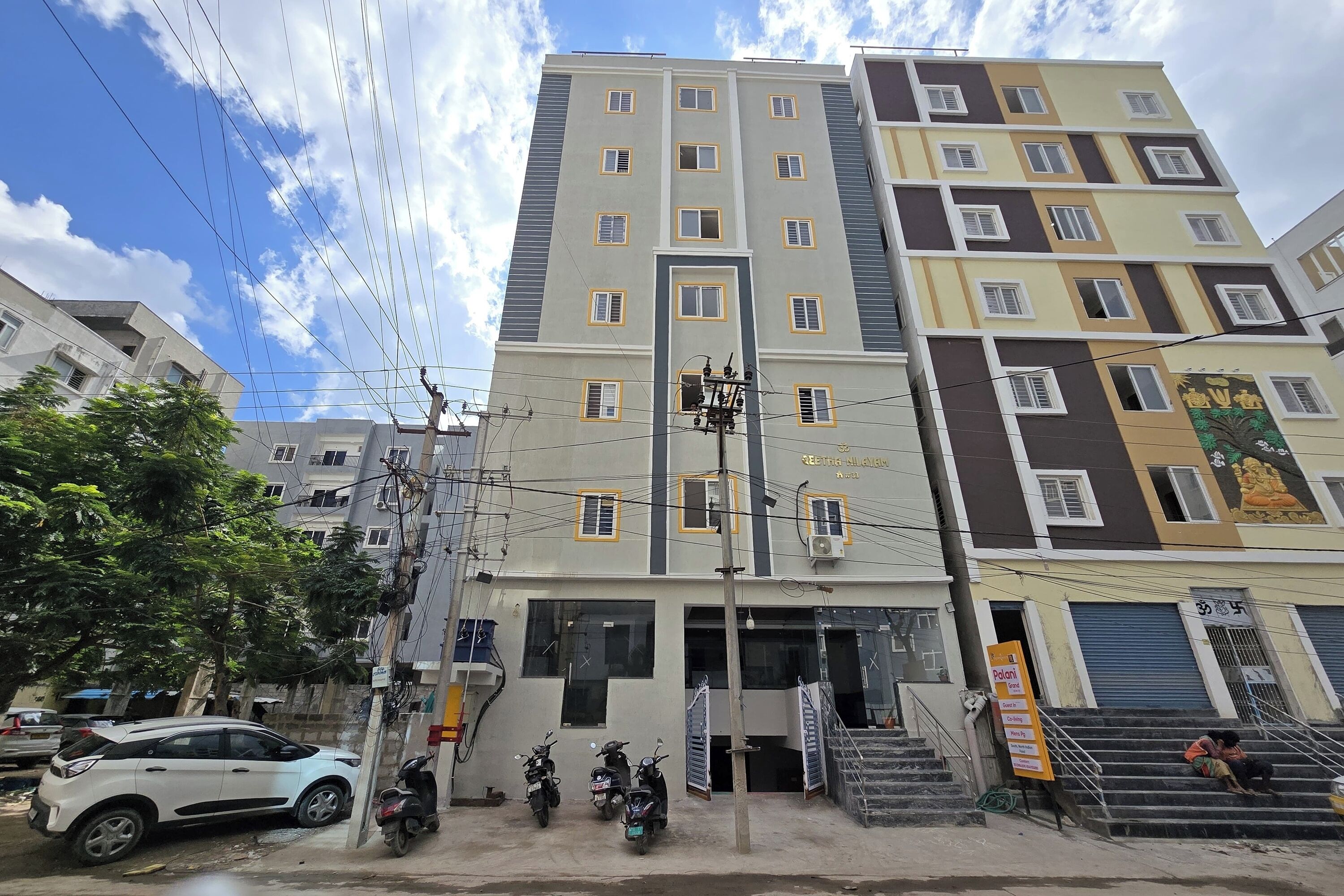 A multi-story building with several windows and a signboard.