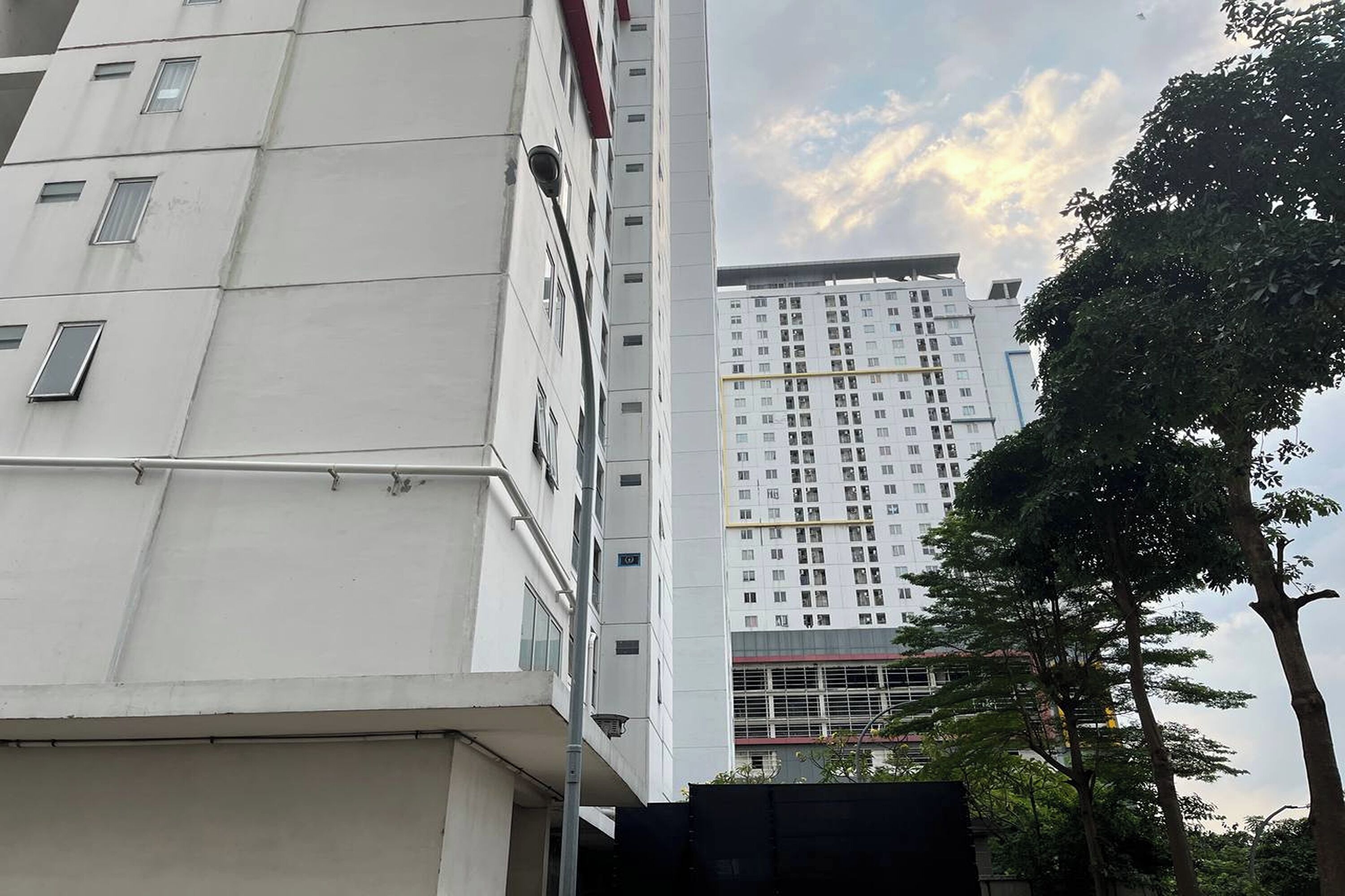 A multi-story building with a modern architectural design, featuring a prominent vertical structure and a series of windows.