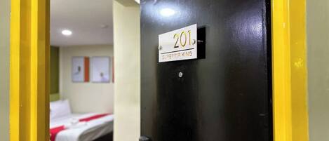 Puerta de una habitación de hotel con un letrero que dice "201 Superior King".
