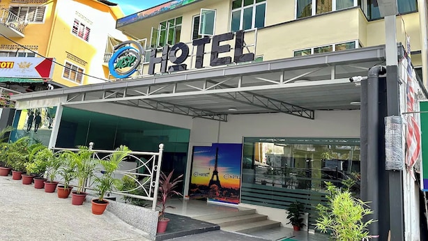 A hotel with a prominent sign, outdoor seating area, and potted plants. - Hotel MSP Bukit Bintang (Kuala Lumpur)