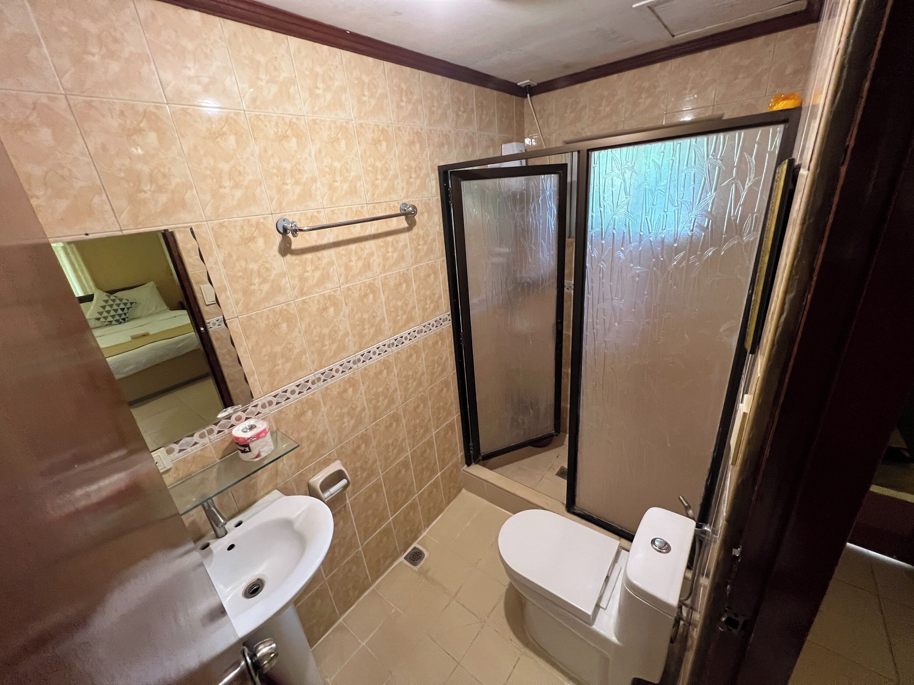 A bathroom with a sink, toilet, and shower.
