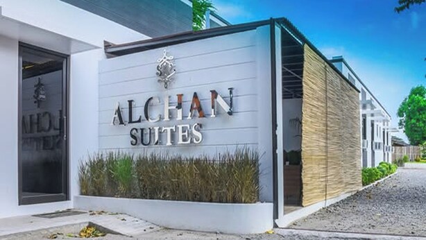 A modern building with the sign "ALCHAN SUITES" indicating a hotel or accommodation establishment. - Alchan Suites (General Santos)