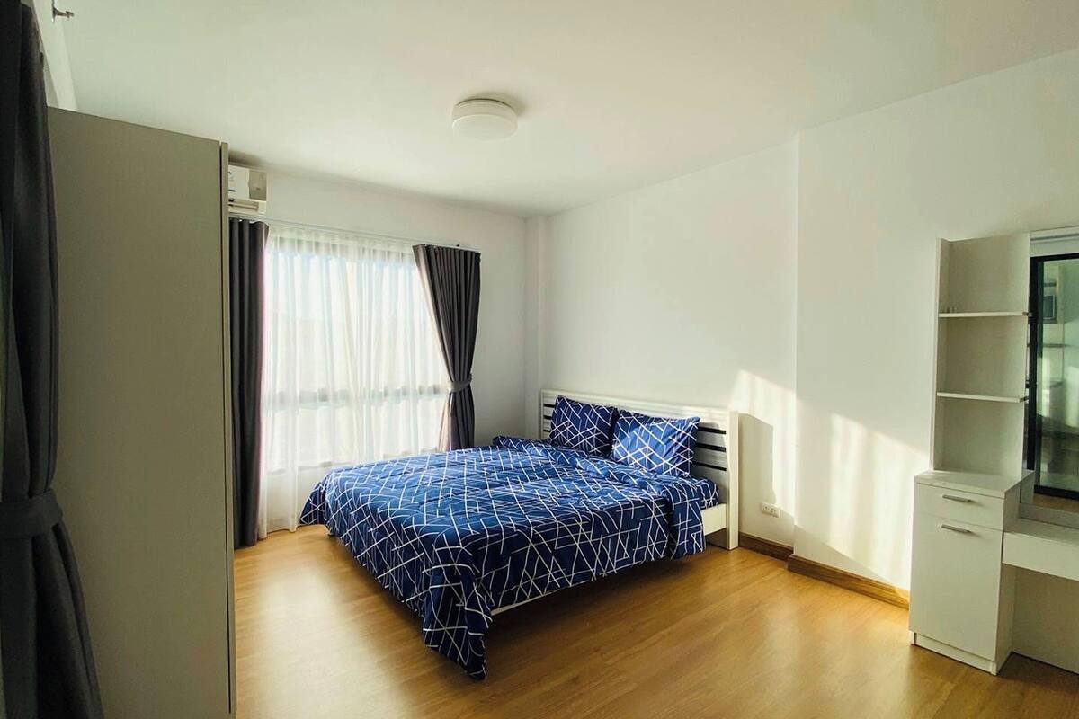Une chambre à coucher avec un lit, une télévision et une armoire.