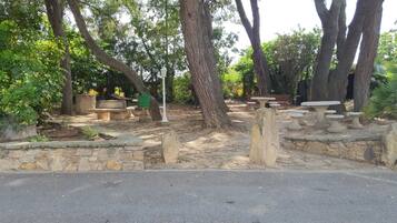 A park with stone benches and a stone wall.