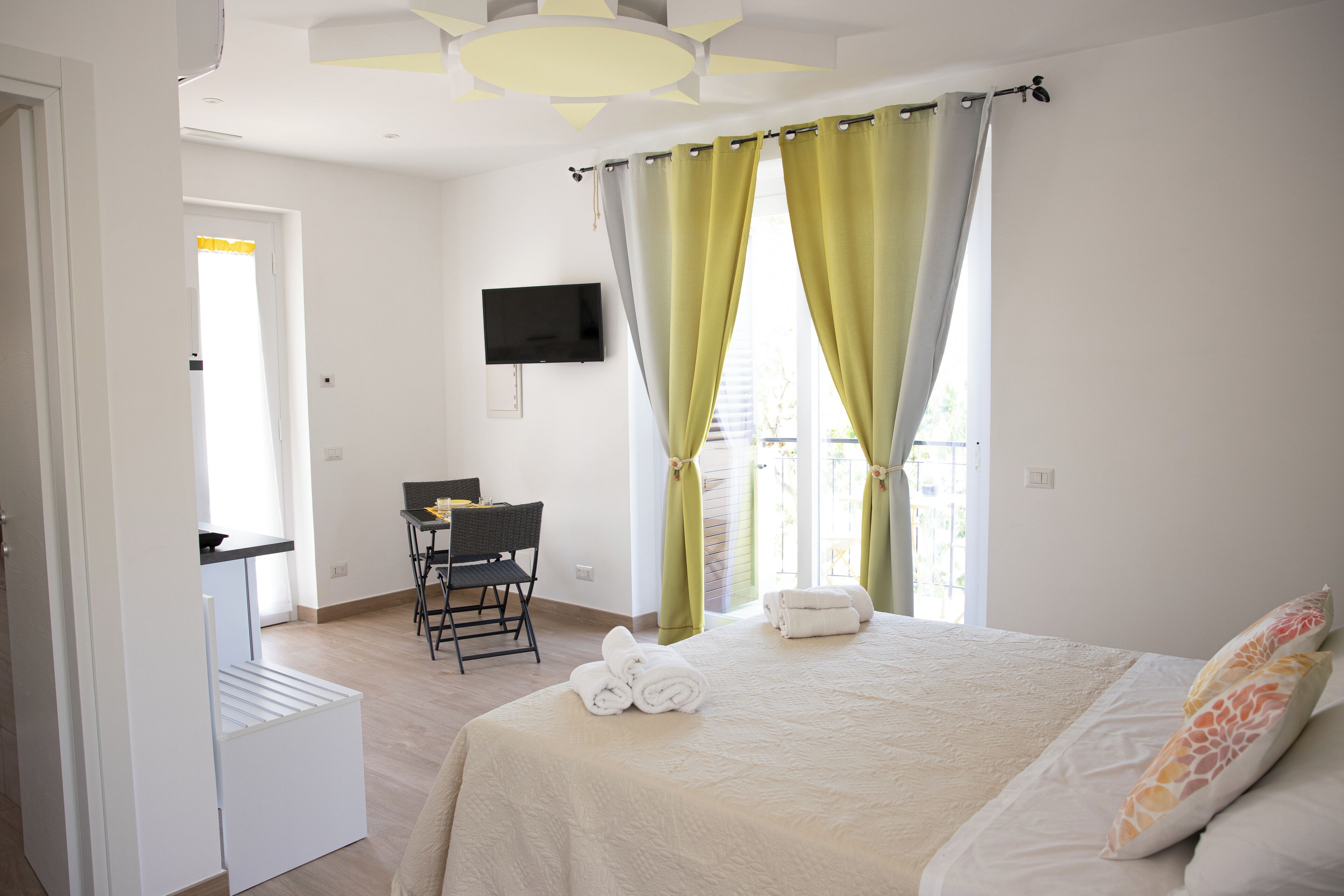 A bedroom with a bed, a desk, and a chair.