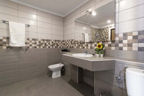 A modern bathroom with a bidet, a sink, and a toilet. - Andalucia 5 - One Bed (Costa Adeje)