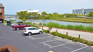 A parking lot with a view of a river and buildings in the background.
