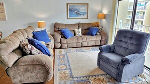 A living room with two sofas, a rug, and a chair. - Canal front on one side, bay on the other! Perfect midtown 2 bedroom condo next to Seacrets and close to everything! Wight Bay #452 (Ocean City)