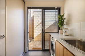Dormitório compartilhado, 1 quarto, sacada, vista para o jardim | Lavanderia