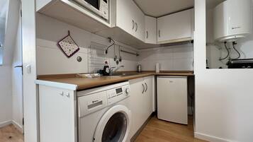 Fridge, microwave, cookware/dishes/utensils, dining tables