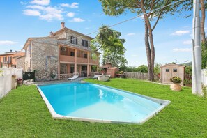 A two-story stone house with a swimming pool, a fenced yard, and a small wooden structure. - Borgo Panicale Apartments (Panicale)
