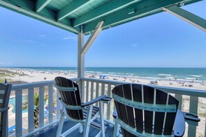 A beach view from a covered deck with two Adirondack chairs. - Sea Watch VII 204 - 2 Bedroom 2 Bath Oceanfront Condo (Garden City Beach)