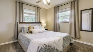 A bedroom with a bed, curtains, a ceiling fan, and a window. - 10 Mi to Dtwn Cincinnati: Home w/ Patio & Yard! (Cincinnati)