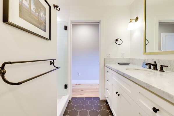 A bathroom with a white vanity, a large mirror, and a hexagonal tile floor. - Tranquil Santa Rosa Home w/ Private Pool & Views! (Santa Rosa)