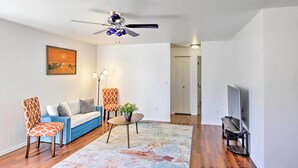 A living room with a sofa, two patterned chairs, a coffee table, a ceiling fan, a TV, and a painting on the wall. - Central Tacoma Escape < 2 Mi From The Tacoma Dome! (Tacoma)