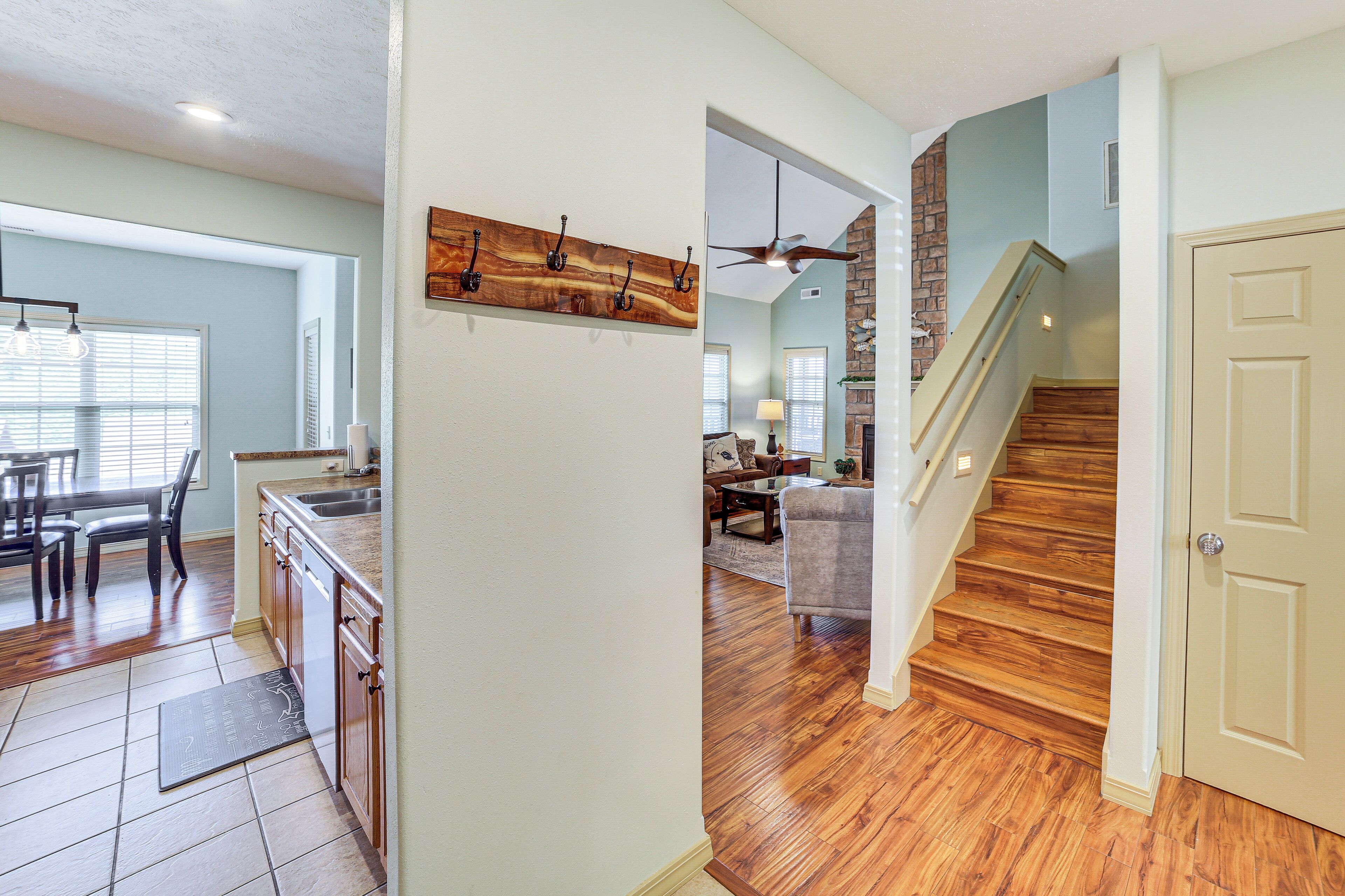 A modern kitchen with wooden cabinets and a dining area with a table and chairs.