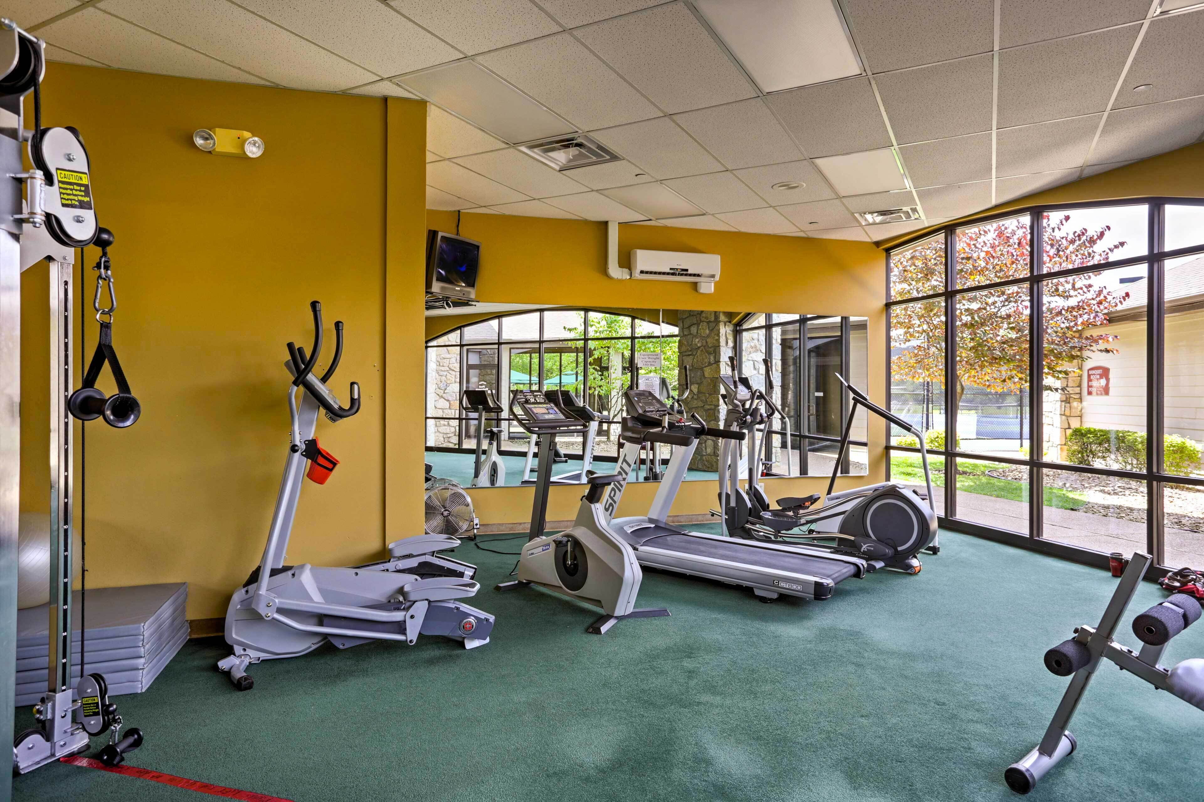 A gym with treadmills, elliptical machines, and weight equipment.