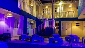 A multi-level hotel with a pool area, outdoor seating, and a staircase. - Pousada Maresia Buzios (Buzios)